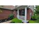 Close up of charming porch featuring a bench, white railings and brick facade at 5189 Bally Bunion Dr, Avon, IN 46123
