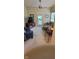 Cozy living room with neutral carpet, a ceiling fan, comfortable seating, and a door leading to outdoor space at 5189 Bally Bunion Dr, Avon, IN 46123