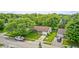 Aerial view of the home showcasing its location in a lush, green neighborhood with mature trees at 5401 Padre Ln, Indianapolis, IN 46237