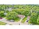 Aerial view of the residence showing the lush greenery, neighborhood, detached garage, and proximity to nearby amenities at 5401 Padre Ln, Indianapolis, IN 46237