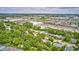 Expansive aerial view captures a neighborhood with commercial area and city skyline visible in the distance at 5401 Padre Ln, Indianapolis, IN 46237