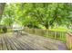 Back deck features a table and is surrounded by lush green trees creating a great outdoor space at 5401 Padre Ln, Indianapolis, IN 46237