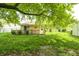 Expansive backyard featuring a quaint deck, lush greenery and large trees at 5401 Padre Ln, Indianapolis, IN 46237