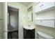Bathroom with single vanity, a mirror, and a cabinet for extra storage at 5401 Padre Ln, Indianapolis, IN 46237