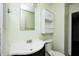 A bathroom features a white sink, toilet, mirror, and cabinet for ample storage at 5401 Padre Ln, Indianapolis, IN 46237