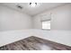 A bedroom features gray walls, wood-look flooring, and natural light from the window at 5401 Padre Ln, Indianapolis, IN 46237