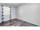 A bright bedroom features gray walls, wood-look flooring, natural light, and striped curtains at 5401 Padre Ln, Indianapolis, IN 46237