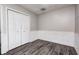 A bedroom features gray walls, wood-look flooring, and a closet for ample storage at 5401 Padre Ln, Indianapolis, IN 46237