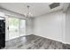 Bright dining area with sliding glass doors that open to the deck and modern gray flooring at 5401 Padre Ln, Indianapolis, IN 46237