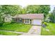 Charming single-Gathering home featuring a well-manicured front yard and an attached garage at 5401 Padre Ln, Indianapolis, IN 46237