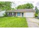 Ranch home featuring brick and siding exterior, an attached garage and a front yard at 5401 Padre Ln, Indianapolis, IN 46237