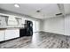 Open-concept kitchen featuring white cabinets, laminate countertops, and black appliances at 5401 Padre Ln, Indianapolis, IN 46237
