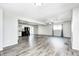 Spacious living room featuring modern gray flooring, lots of natural light, and an open-concept design at 5401 Padre Ln, Indianapolis, IN 46237