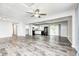 Open-concept living area with sleek gray flooring, offering seamless flow to the kitchen and dining at 5401 Padre Ln, Indianapolis, IN 46237