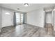Bright living room featuring stylish gray vinyl flooring, white walls, and ample natural light at 5401 Padre Ln, Indianapolis, IN 46237