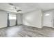 Bright living room featuring stylish gray vinyl flooring, white walls, and ample natural light at 5401 Padre Ln, Indianapolis, IN 46237