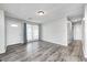 Inviting living room with modern gray wood flooring and abundant natural light from a large window at 5401 Padre Ln, Indianapolis, IN 46237