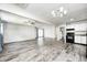 Open-concept living space featuring modern flooring and a seamless transition to the kitchen and dining areas at 5401 Padre Ln, Indianapolis, IN 46237