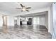 Open-concept living room and kitchen area featuring black appliances and sliding glass doors at 5401 Padre Ln, Indianapolis, IN 46237