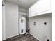 A utility room features the water heater and storage shelves and cabinets at 5401 Padre Ln, Indianapolis, IN 46237
