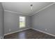 Bedroom with neutral gray walls, wood look flooring, and window for natural light at 5515 W Morris St, Indianapolis, IN 46241