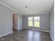 Bedroom with hardwood floors, neutral walls, and lots of natural light with attached bathroom at 5515 W Morris St, Indianapolis, IN 46241