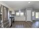 Bright kitchen featuring stainless steel appliances, sleek cabinets, hardwood flooring, and ample natural light at 5515 W Morris St, Indianapolis, IN 46241