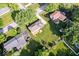 This aerial view shows a home with a backyard deck, surrounded by mature trees at 567 Hawthorne Dr, Carmel, IN 46033