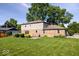 The backyard of this home offers lots of greenspace with lush lawn, mature trees and patio area at 567 Hawthorne Dr, Carmel, IN 46033