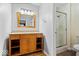 Bathroom with a wood vanity, granite countertop, decorative mirror and shower at 567 Hawthorne Dr, Carmel, IN 46033