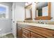 Bathroom vanity features dual sinks, granite countertops, and wood cabinetry at 567 Hawthorne Dr, Carmel, IN 46033