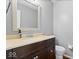 This bathroom features a dark vanity cabinet with a stone countertop and an elegant framed mirror at 567 Hawthorne Dr, Carmel, IN 46033