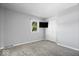 Bedroom with neutral carpet, television, closet, and a sunlit window at 567 Hawthorne Dr, Carmel, IN 46033