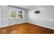 Cozy bedroom with hardwood floors, large window, and neutral paint creating a relaxing atmosphere at 567 Hawthorne Dr, Carmel, IN 46033