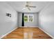 Spacious bedroom featuring hardwood floors, a ceiling fan, and a window with exterior views at 567 Hawthorne Dr, Carmel, IN 46033