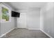 Bedroom features neutral carpet, a television, closet, and window with outside view at 567 Hawthorne Dr, Carmel, IN 46033