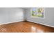 Bedroom featuring hardwood floors and a window with views of the exterior at 567 Hawthorne Dr, Carmel, IN 46033