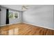 Bedroom featuring hardwood flooring and bright window with outdoor view at 567 Hawthorne Dr, Carmel, IN 46033
