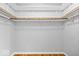 Walk-in closet featuring wood rods and shelves, perfect for storage at 567 Hawthorne Dr, Carmel, IN 46033