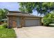 A two car garage with a brick facade and a door to access the house at 567 Hawthorne Dr, Carmel, IN 46033