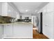 Kitchen features stainless steel appliances, granite countertops, white cabinets, and hardwood floors at 567 Hawthorne Dr, Carmel, IN 46033