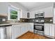 Updated kitchen featuring stainless steel appliances, granite countertops, and white cabinets at 567 Hawthorne Dr, Carmel, IN 46033