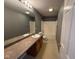 The bathroom features a vanity with a sink, a full mirror, and a shower-tub combination at 5683 James Blair Dr, Indianapolis, IN 46234