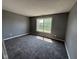 This bedroom features new carpet, neutral walls, and a window providing natural light at 5683 James Blair Dr, Indianapolis, IN 46234