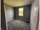 Bedroom featuring new carpet, neutral walls, and a window at 5683 James Blair Dr, Indianapolis, IN 46234