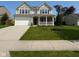 Charming two-story home boasts a well-manicured lawn, attached two car garage, and welcoming front porch at 5683 James Blair Dr, Indianapolis, IN 46234