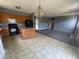 This kitchen features an island, black appliances, oak cabinets, and vinyl flooring at 5683 James Blair Dr, Indianapolis, IN 46234