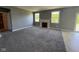 A large living room with a fireplace, two large windows, neutral gray walls and tile flooring nearby at 5683 James Blair Dr, Indianapolis, IN 46234