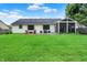 Overlooking large backyard, featuring a well-manicured lawn, patio furniture, and a screened in porch at 572 Quail Ridge Dr, Westfield, IN 46074