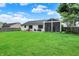 Vast green backyard with a charming patio area, comfortable seating, and screened-in back porch at 572 Quail Ridge Dr, Westfield, IN 46074